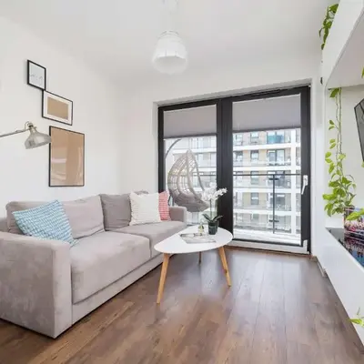 Light Grey Apartment in Cracow with Furnished Balcony by Noclegi Renters