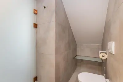 a bathroom with a toilet and a shower at Volare Balice in Cholerzyn
