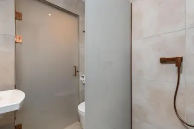 a bathroom with a shower and a toilet and a sink at Volare Balice in Cholerzyn