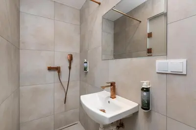 a bathroom with a sink and a mirror at Volare Balice in Cholerzyn