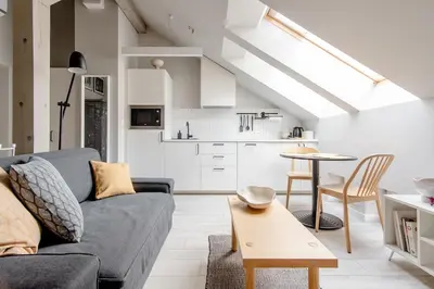 a living room with a couch and a table at Charming designer attic in Kraków