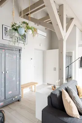 a living room with a couch and a table at Charming designer attic in Kraków