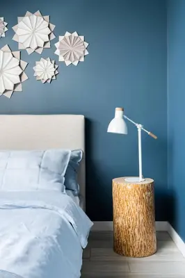 a bedroom with a bed and a table with a lamp at Charming designer attic in Kraków