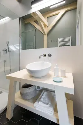 a bathroom with a white sink and a shower at Charming designer attic in Kraków