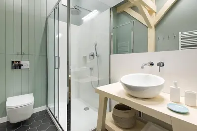 a bathroom with a sink and a shower at Charming designer attic in Kraków