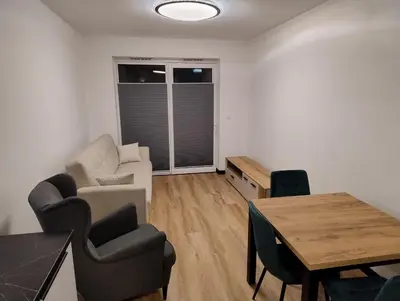 a living room with a couch and a table at Podłęże Trawniki Industrial Zone