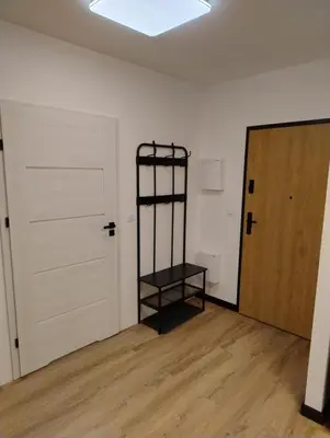 an empty room with a black shelf next to a door at Podłęże Trawniki Industrial Zone