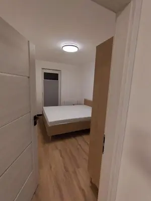 a small bedroom with a bed and a closet at Podłęże Trawniki Industrial Zone