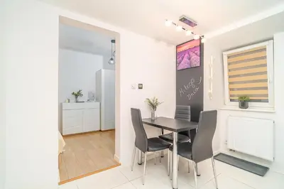 a dining room with a table and chairs at Kraków Apt - Top Location, Old Town Nearby - by Rentujemy in Kraków