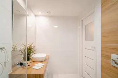 a white bathroom with a sink and a toilet at Kraków Apt - Top Location, Old Town Nearby - by Rentujemy in Kraków