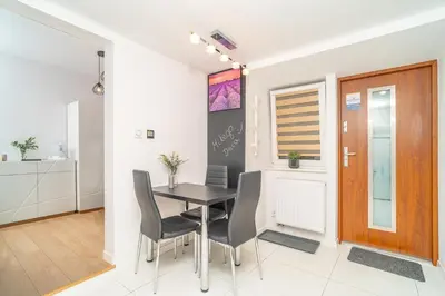 a kitchen and dining room with a table and chairs at Kraków Apt - Top Location, Old Town Nearby - by Rentujemy in Kraków
