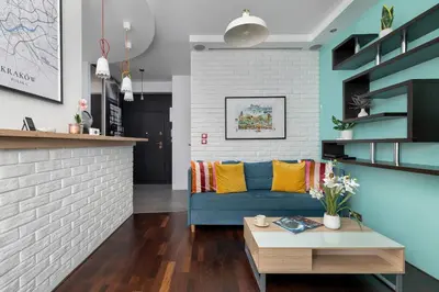 a living room with a blue couch and a brick wall at Meiera Krakow Charming Apartment with Parking and Air Conditioning by Noclegi Renters in Kraków