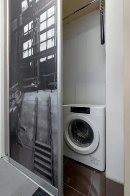 a washing machine in a room with a window at Meiera Krakow Charming Apartment with Parking and Air Conditioning by Noclegi Renters in Kraków