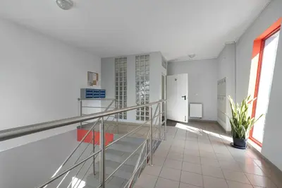 a staircase in a room with white walls and windows at Meiera Krakow Charming Apartment with Parking and Air Conditioning by Noclegi Renters in Kraków