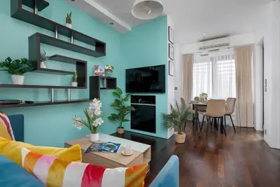 a living room with a couch and a table at Meiera Krakow Charming Apartment with Parking and Air Conditioning by Noclegi Renters in Kraków
