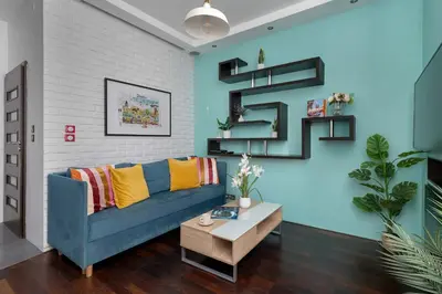 a living room with a blue couch and a table at Meiera Krakow Charming Apartment with Parking and Air Conditioning by Noclegi Renters in Kraków