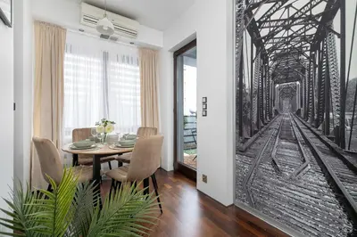 a dining room with a painting of a railroad bridge at Meiera Krakow Charming Apartment with Parking and Air Conditioning by Noclegi Renters in Kraków