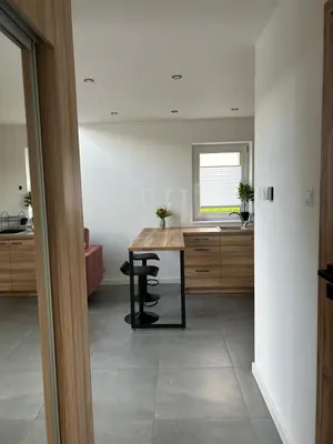 a kitchen with a table in the middle of a room at 4 Żywioły-Noclegi w Beskidach basen sauna jacuzzi in Koziniec