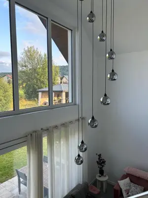 a living room with three windows and a couch at 4 Żywioły-Noclegi w Beskidach basen sauna jacuzzi in Koziniec