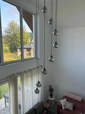 a living room with three windows and a couch at 4 Żywioły-Noclegi w Beskidach basen sauna jacuzzi in Koziniec