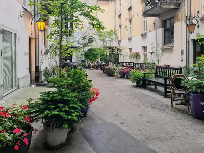 a street filled with lots of plants and benches at Old Town PLAC SZCZEPAŃSKI Premium Apartments in Kraków