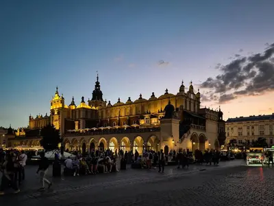a large building with people standing in front of it at Old Town PLAC SZCZEPAŃSKI Premium Apartments in Kraków
