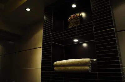 a bathroom with a mirror and a towel at Color Apartment in Kraków