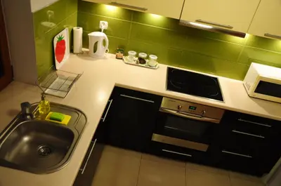 a kitchen with a sink and a stove at Color Apartment in Kraków