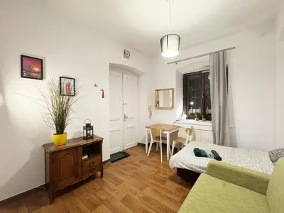 a living room with a couch and a table at Cozy Asnyka in Kraków