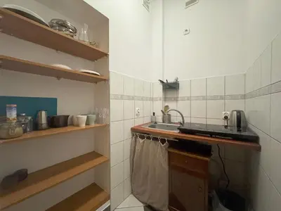 a small kitchen with a sink and a counter at Cozy Asnyka in Kraków