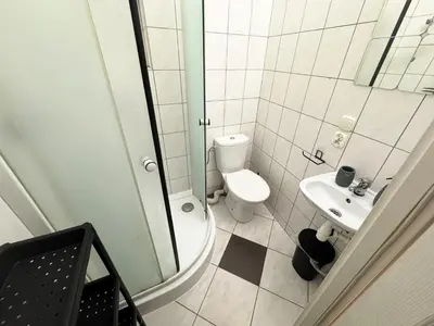 a small bathroom with a toilet and a sink at Cozy Asnyka in Kraków