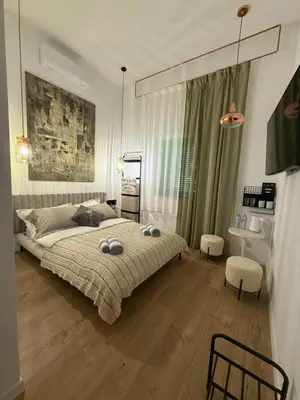 a bedroom with a large bed with two pillows on it at Green Harmony Apartment in Kraków