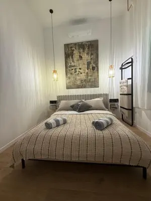 a bedroom with a large bed with two pillows on it at Green Harmony Apartment in Kraków