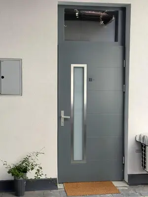 a blue door with a silver handle on a house at Green Harmony Apartment in Kraków