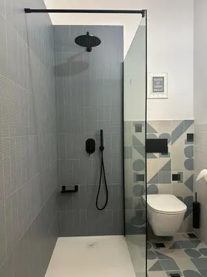 a bathroom with a shower and a toilet at Green Harmony Apartment in Kraków