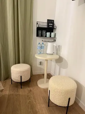 a room with two stools and a table with water bottles at Green Harmony Apartment in Kraków