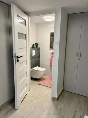 a bathroom with a tub and a toilet in a room at Gorczańska Przystań in Zasadne