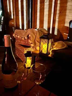a bottle of wine and two glasses on a table at Gorczańska Przystań in Zasadne