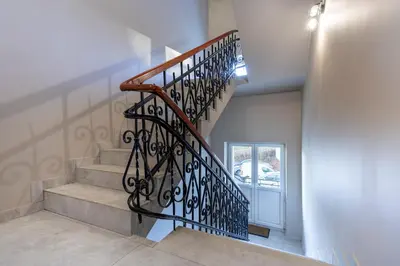 a staircase with a wrought iron railing in a house at ANTA Salt Mine City in Wieliczka