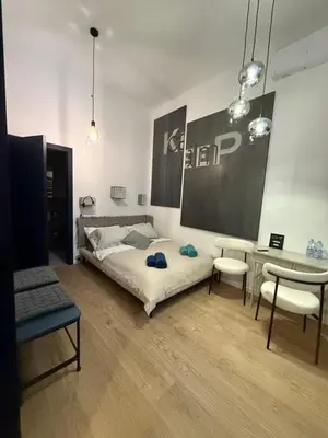 a bedroom with a bed and a desk and chairs at Blue Harmony Apartment in Kraków