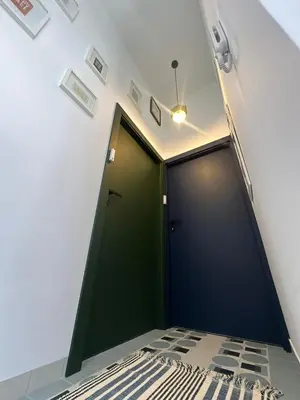 a green door in a room with a bed at Blue Harmony Apartment in Kraków