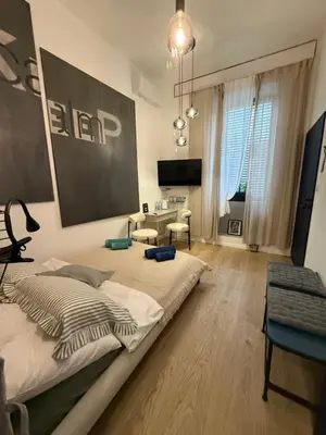 a bedroom with a bed and a living room at Blue Harmony Apartment in Kraków