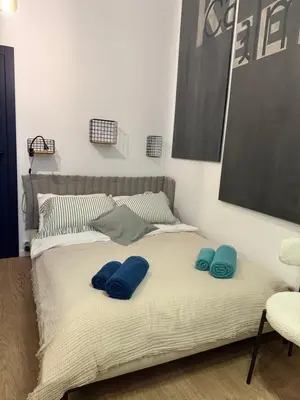 a bed with blue pillows on top of it at Blue Harmony Apartment in Kraków