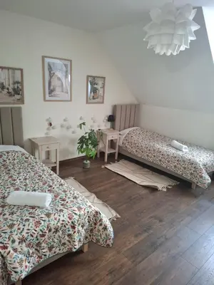 a bedroom with a bed with colorful pillows at Apartamenty TUTERRA IV in Zabagnie