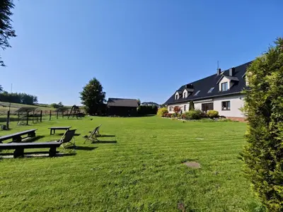 a park with benches in a grass field at Apartamenty TUTERRA IV in Zabagnie