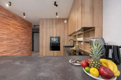 a bowl of fruit on a counter in a kitchen at Elegant & Bright Apartment Zabłocie by Renters Prestige in Kraków