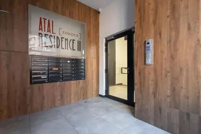 an entrance to a building with a sign on the wall at Elegant & Bright Apartment Zabłocie by Renters Prestige in Kraków