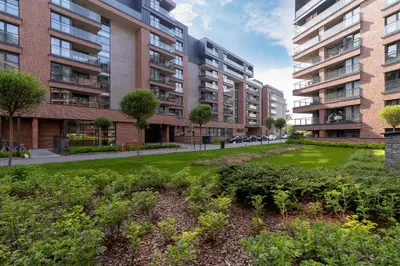 a park in a city with tall buildings at Elegant & Bright Apartment Zabłocie by Renters Prestige in Kraków