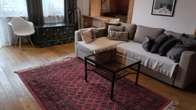 a living room with a couch and a coffee table at Cozy Apartment in Krakow in Kraków