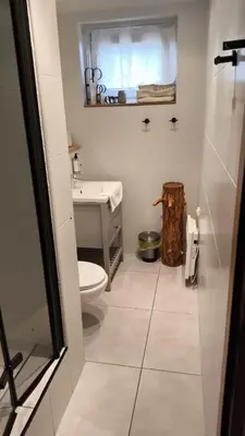 a bathroom with a toilet and a sink at Cozy Apartment in Krakow in Kraków